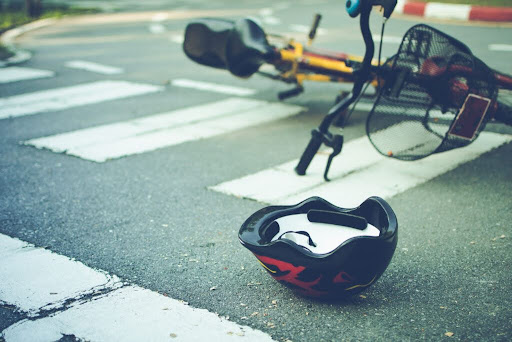 A bicycle and a helmet lie in a Philadelphia crosswalk after being hit by a motor vehicle.