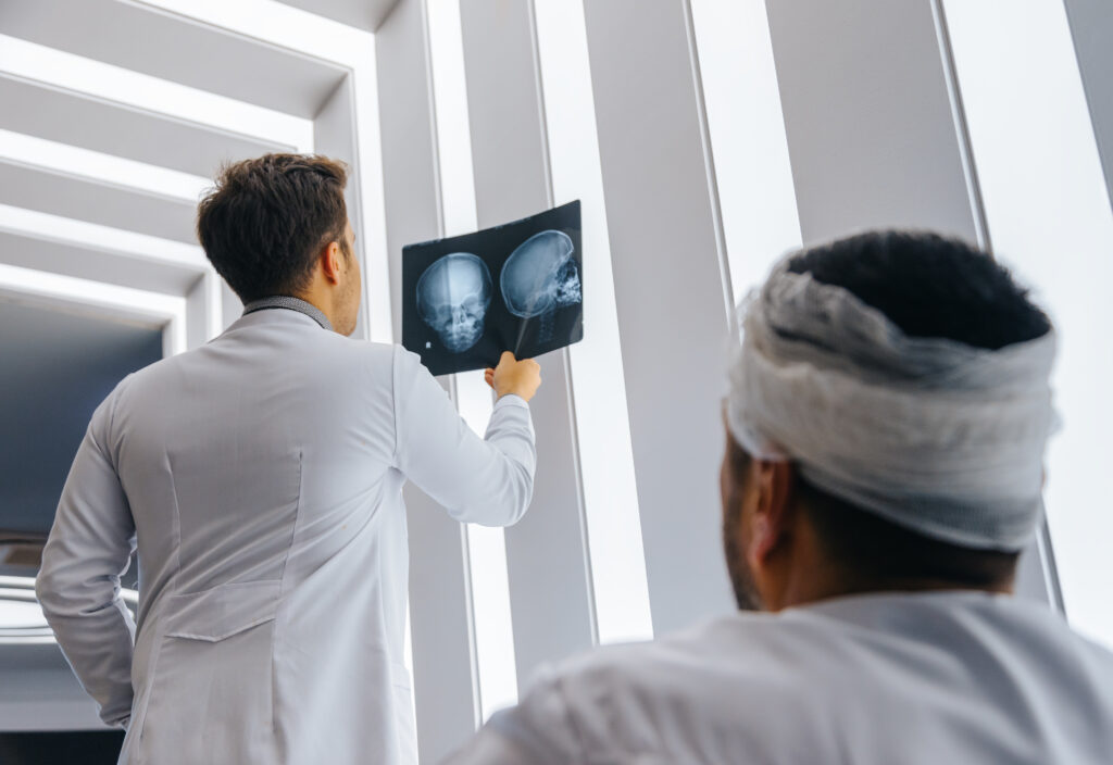 A car accident victim reviews a CAT scan with his doctor.