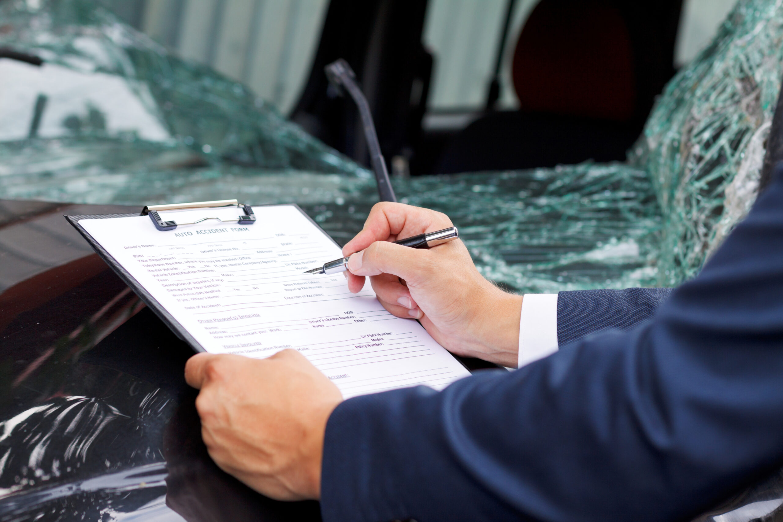 a man is taking notes after a car accident