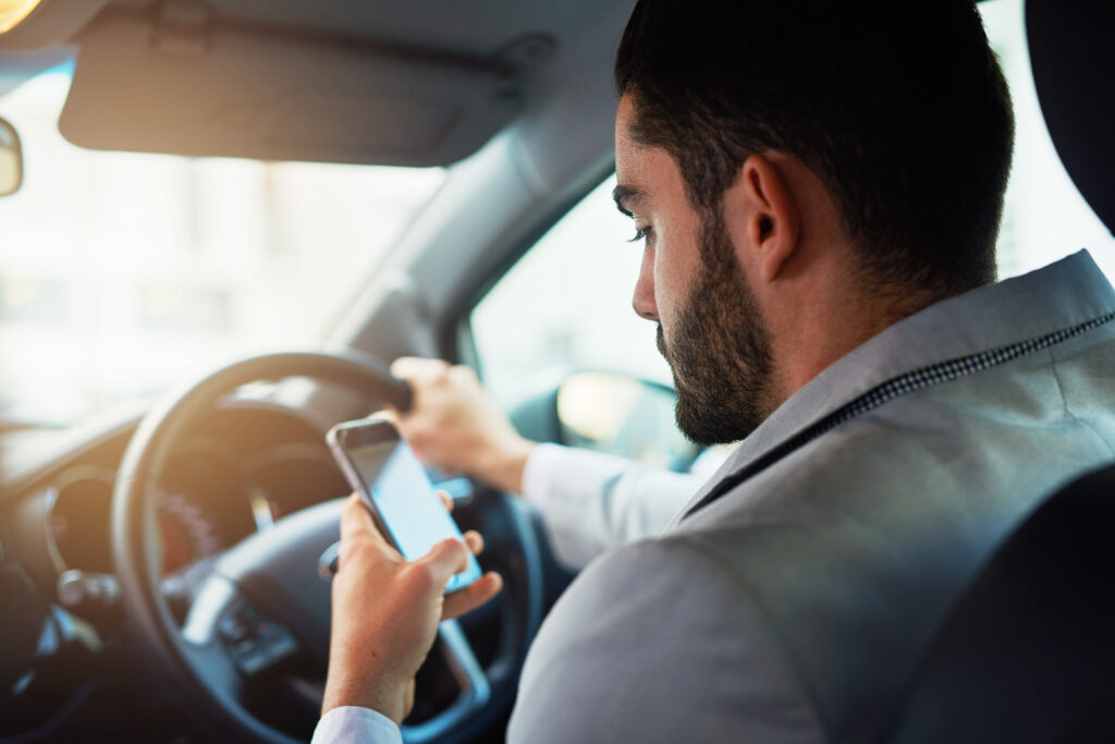 man on his phone while driving