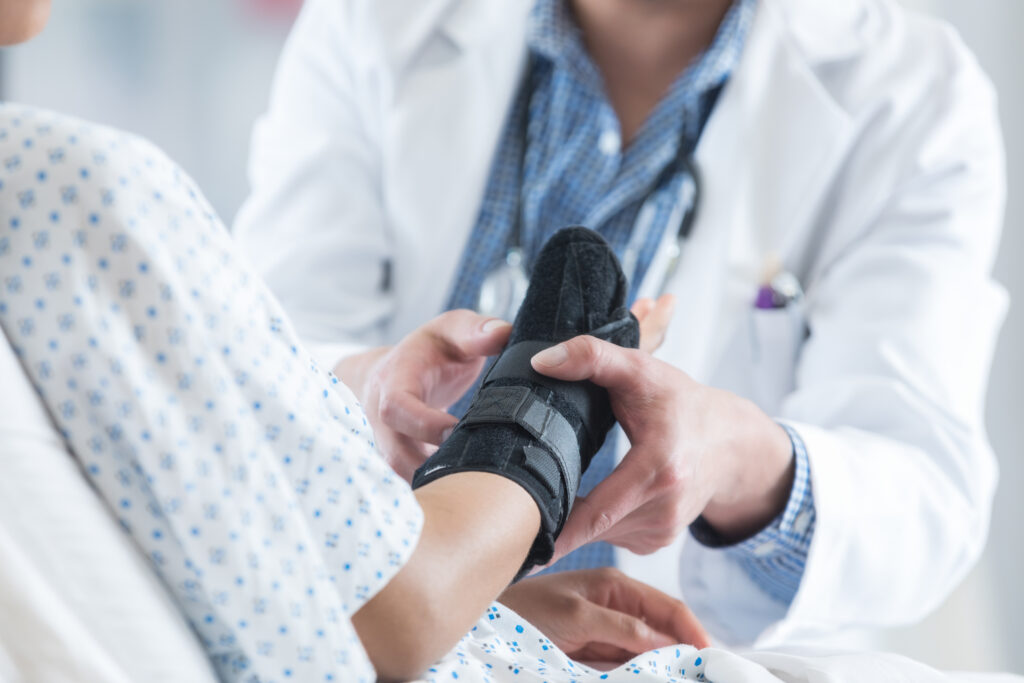 doctor putting a brace on someones arm