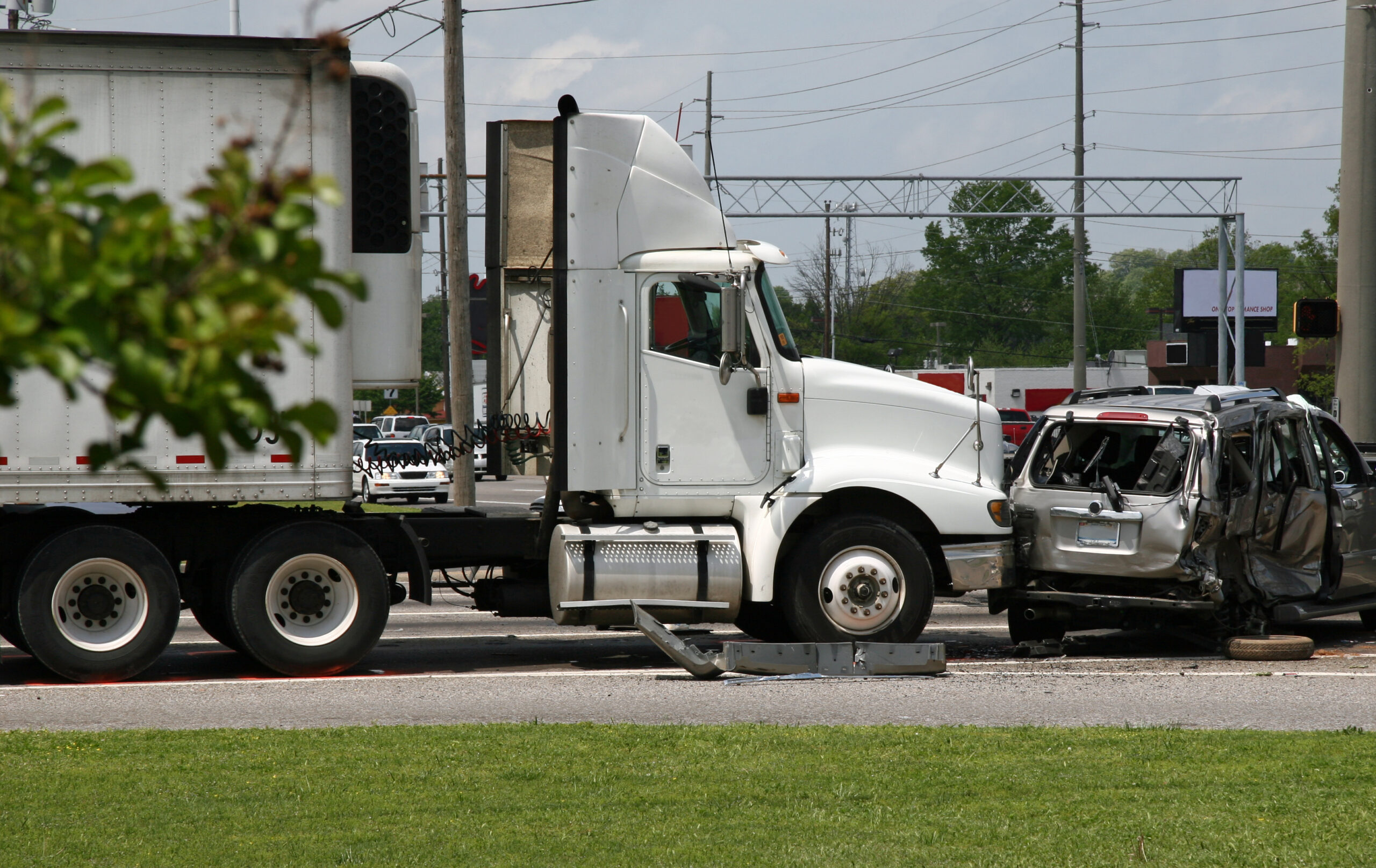 An accident involving a commercial truck and a passenger minivan at an intersection with a red light traffic signal.